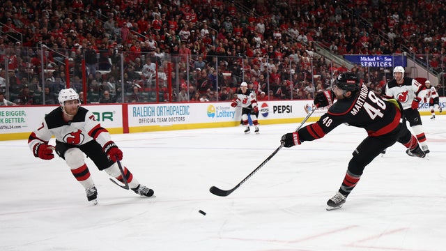 Jordan Martinook #48 of the Carolina Hurricanes attempts a shot on goal past Dougie Hamilton #7 of the New Jersey Devils in the second period in Game Two of the First Round of the 2025 Stanley Cup Playoffs at Lenovo Center on April 22, 2025 in Raleigh, North Carolina. 
